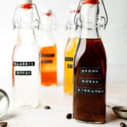 Brown sugar cinnamon syrup in tall glass jar with lid.