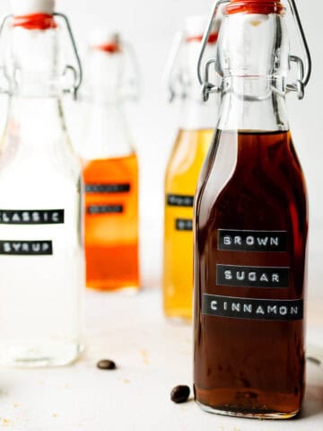 Brown sugar cinnamon syrup in tall glass jar with lid.