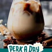 Drop of espresso falling into iced latte.