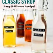 A glass bottle with classic syrup next to some other syrups in bottles.