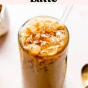Iced caramel latte in a tall glass topped with caramel drizzle.