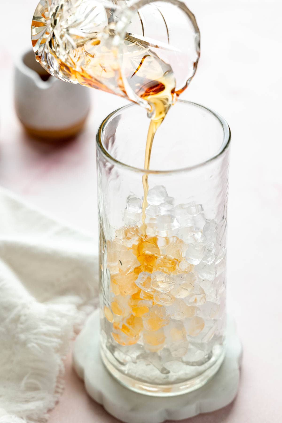 Caramel syrup poured over ice in a tall glass.