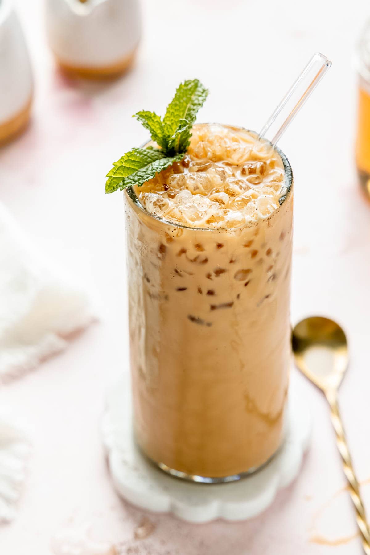 Iced coffee with mint leaves and a spoon