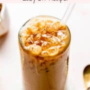 Iced caramel latte in a tall glass topped with caramel drizzle.