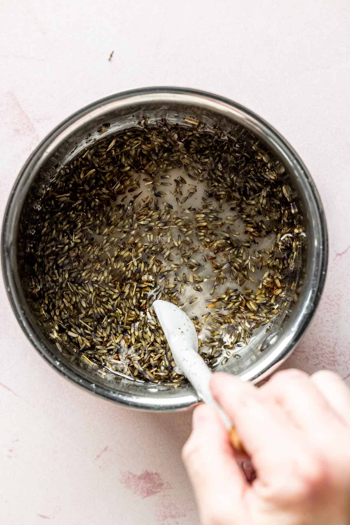 Stirring the lavender syrup in a pan.